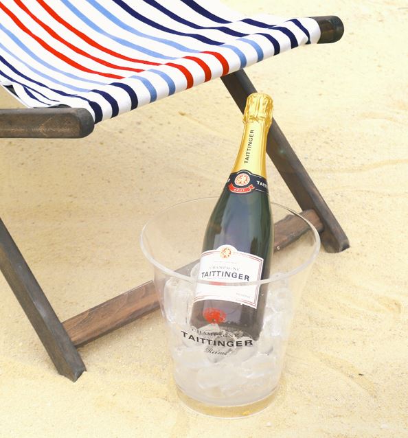 Champagne in ice bucket on beach