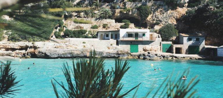 Beach, blue sea, and palm trees in Majorca, Spain