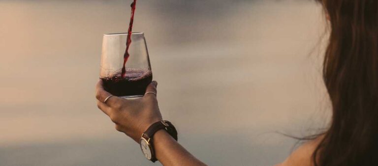 Pouring red wine into wine glass