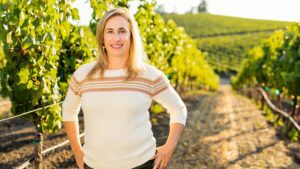 Remi Cohen standing in front of the Domaine Carneros chateau, a medieval-style building modeled after Champagne Taittinger's historic Château de la Marquetterie